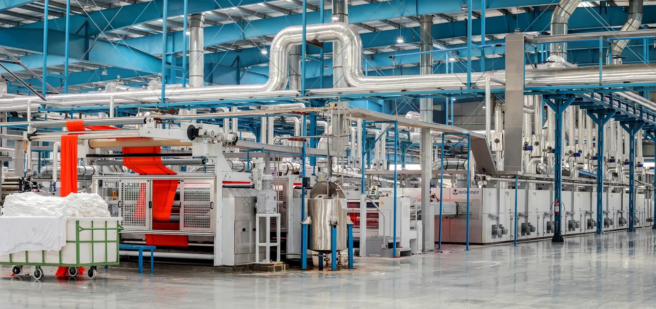 Yarn production machinery with thread moving through the line