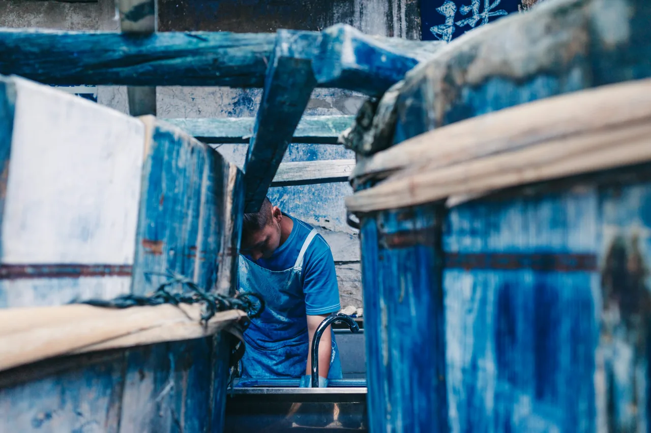 Worker dyeing fabric in a textile workshop